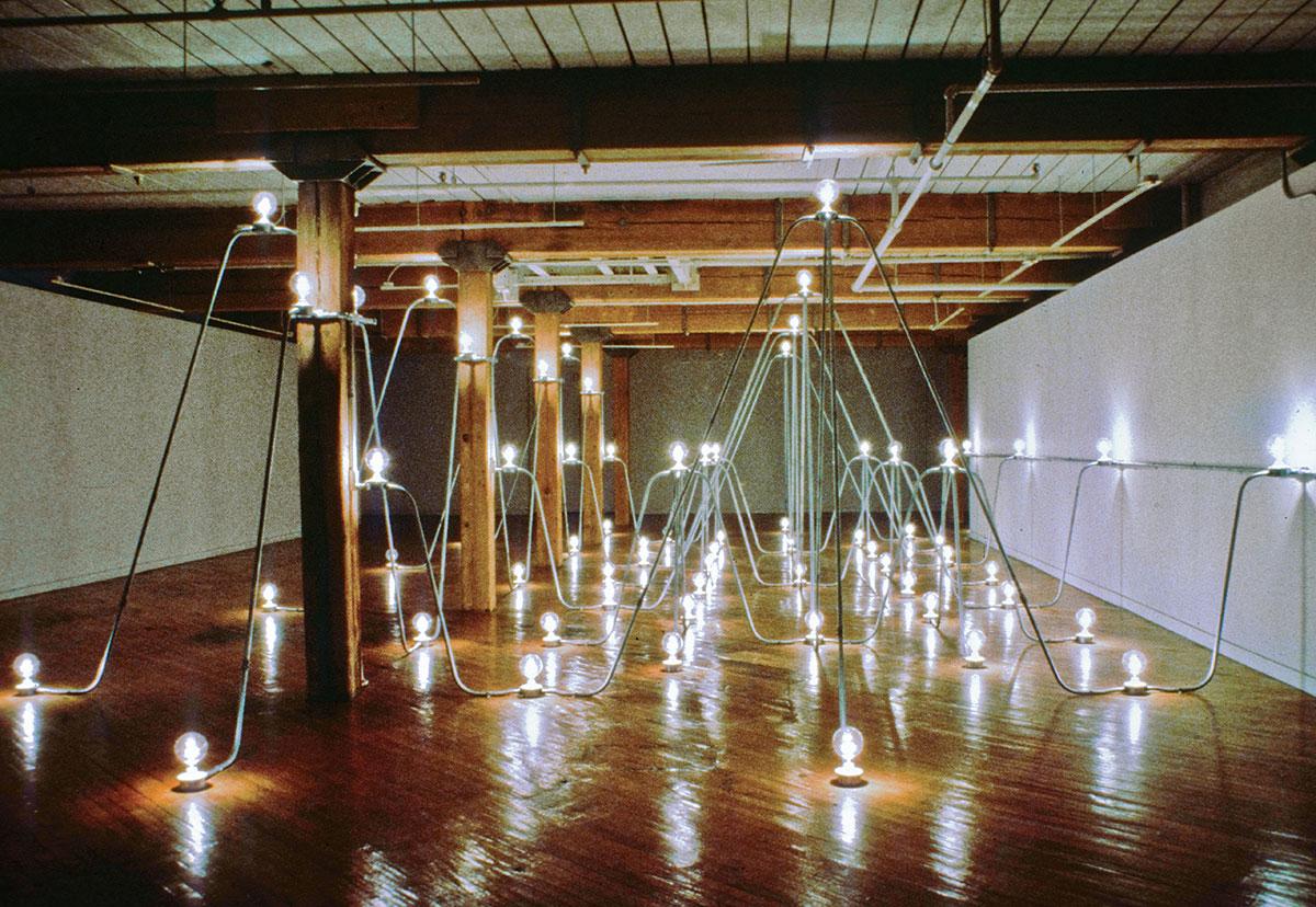 a room filled with lights and conduit in arching rhythmic patterns