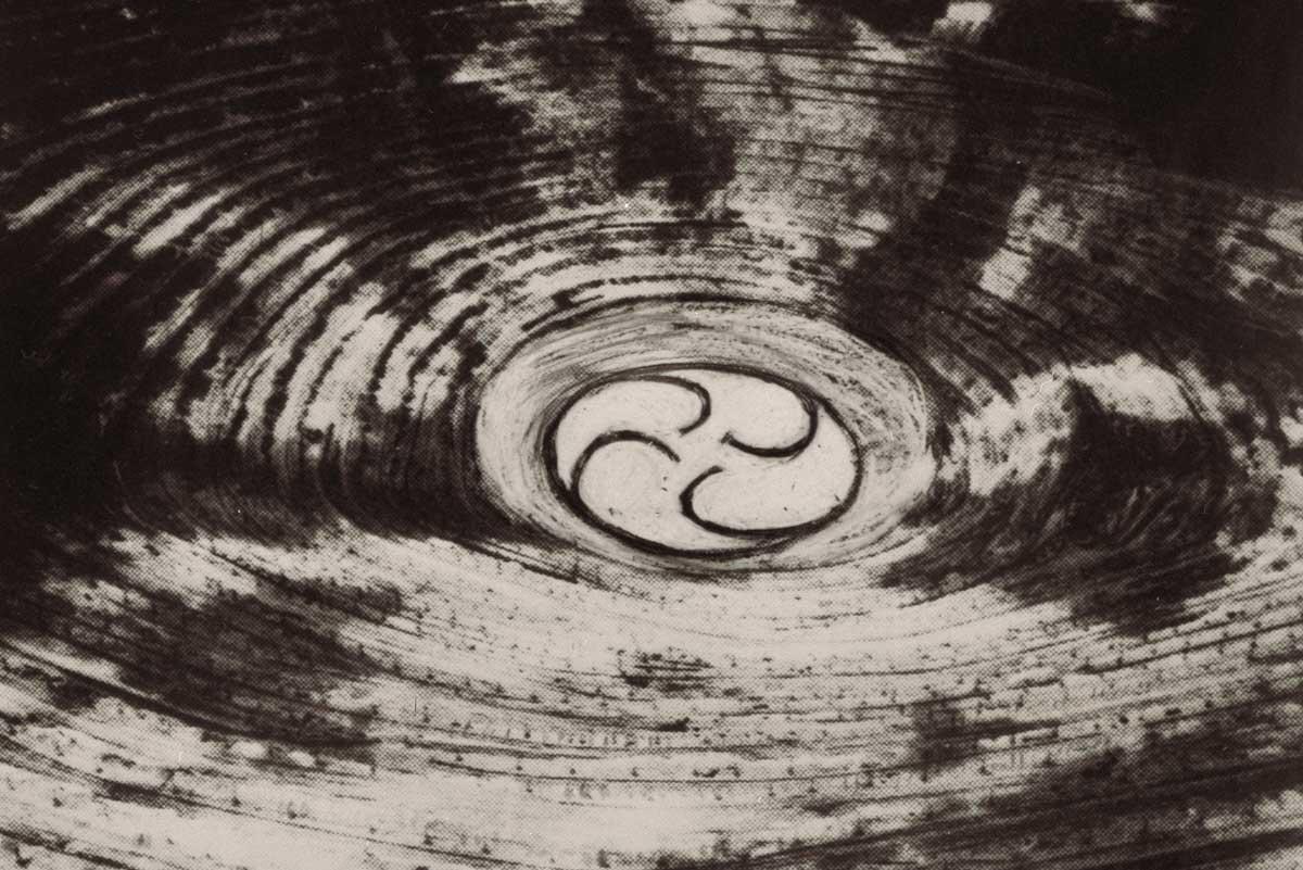 black and white image of the center of a large mine, with spiraling center circle