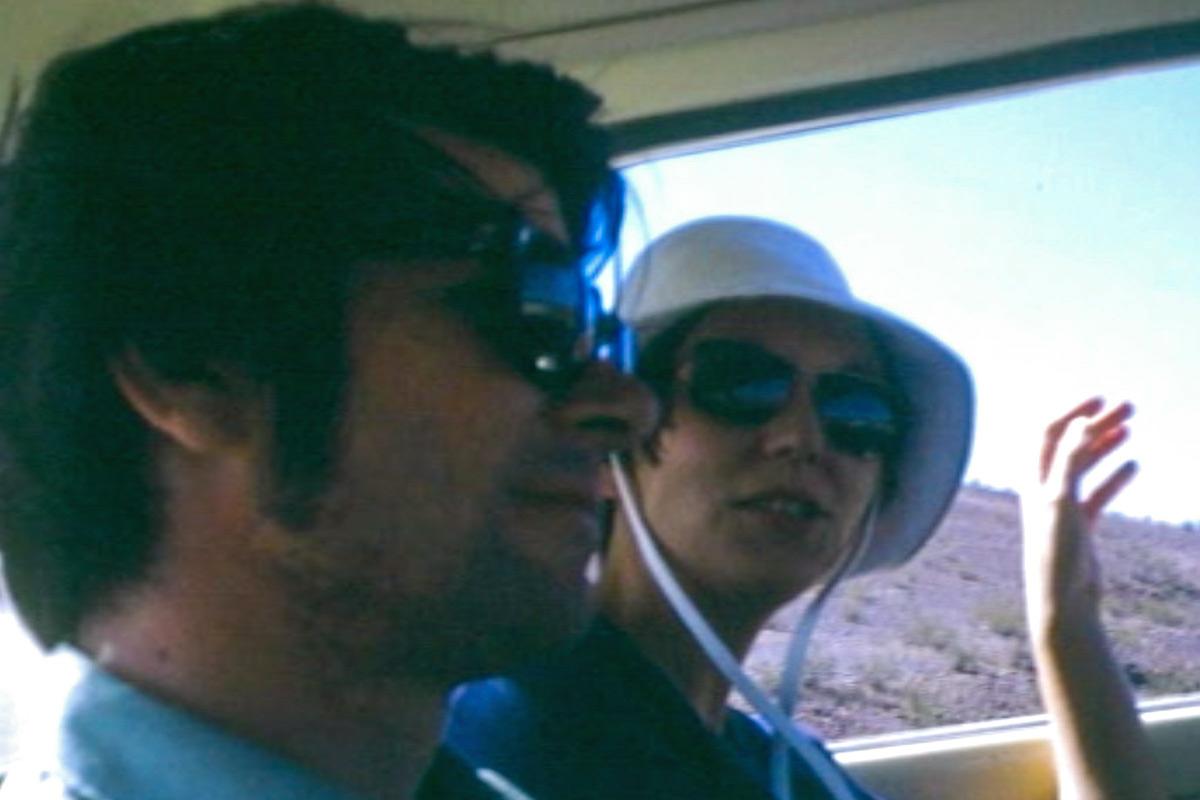 profile view of two people sitting next to each other in the backseat of a car