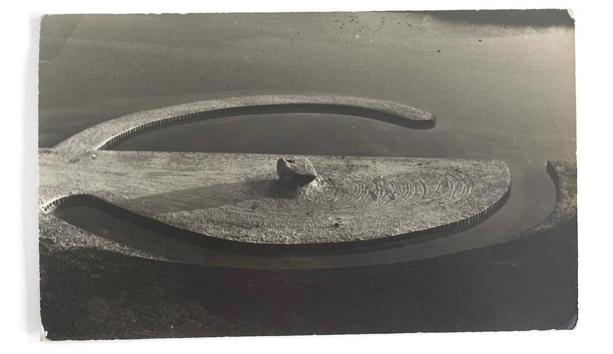 aerial view of land sculpture featuring a large boulder in the center and two semi circular forms