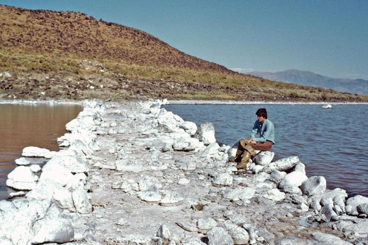 Robert Smithson sitting on the edge of Spiral Jetty