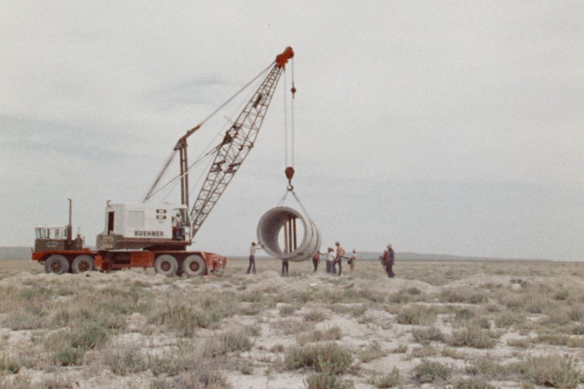 Nancy Holt's Sun Tunnels being lifted into place by a crane