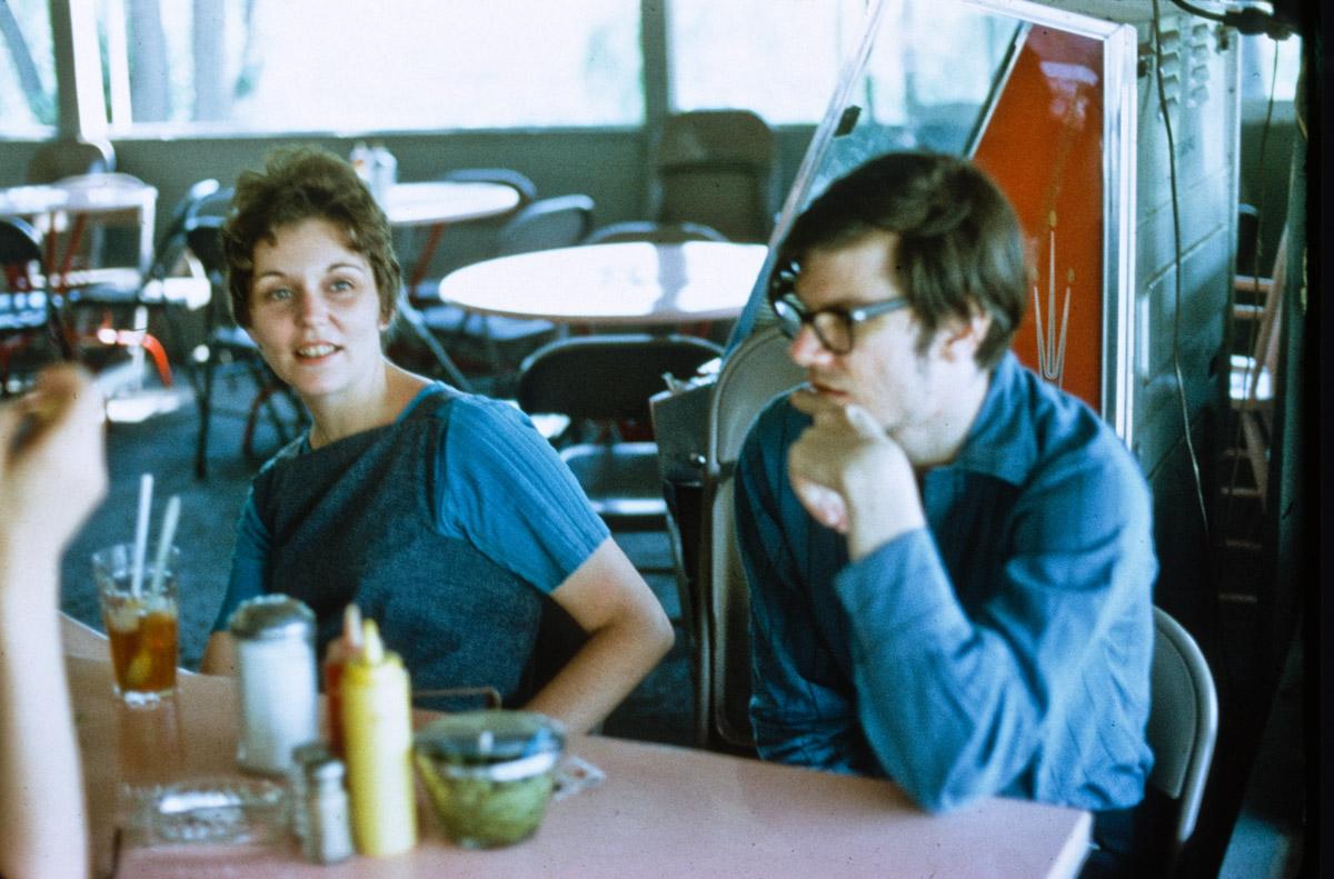 Nancy Holt and Robert Smithson seated at a table in a diner