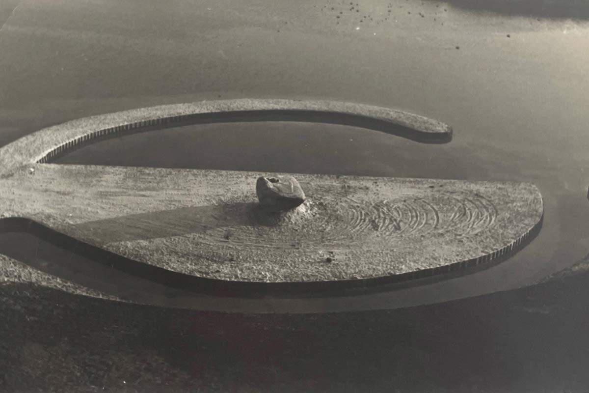 a circular jetty made of sand extending into the water