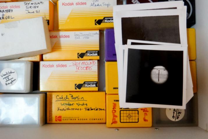 a drawer full of rolls of film and polaroid black and white shots
