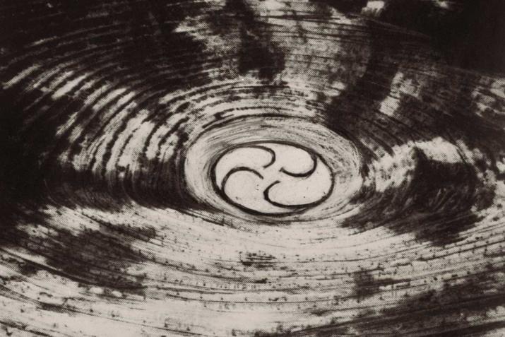 black and white image of the center of a large mine, with spiraling center circle