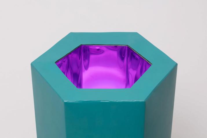 a sculpture by Robert Smithson with a glowing purple center