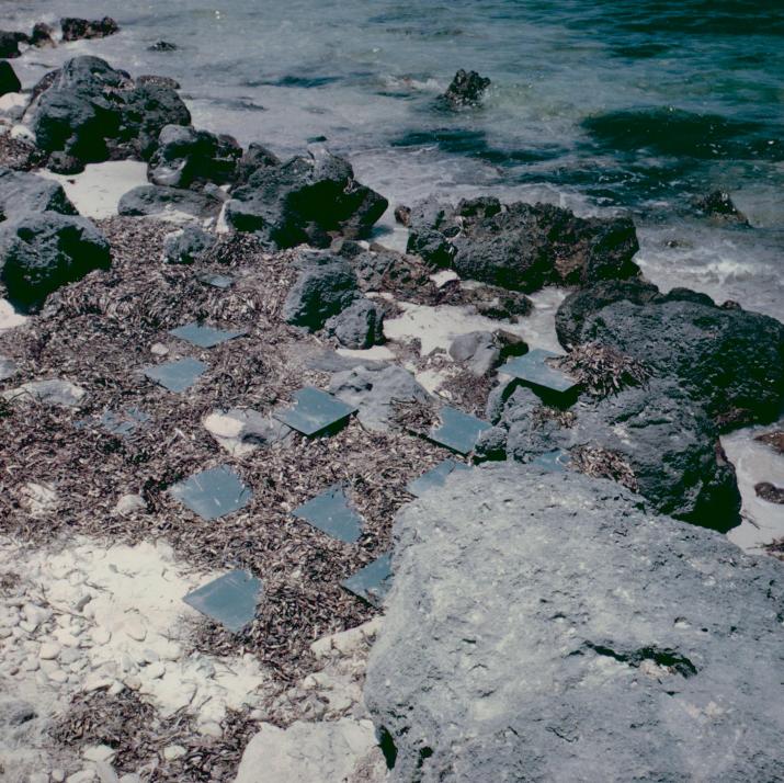 square mirrors on a rocky shore