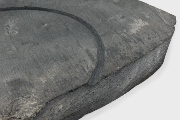 a large piece of slate with a circular incision