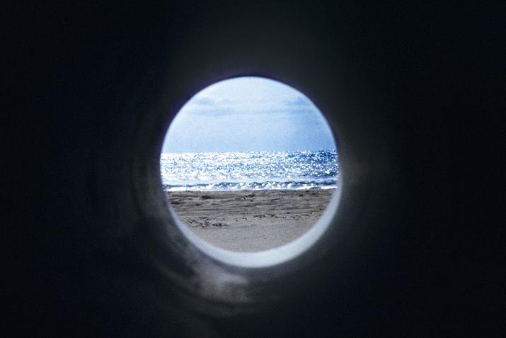 a circular view of a beach and ocean