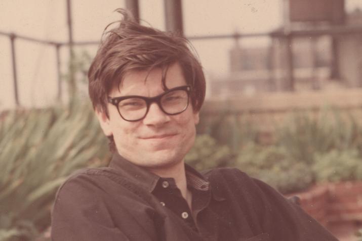 Robert Smithson smiling at the camera on a rooftop
