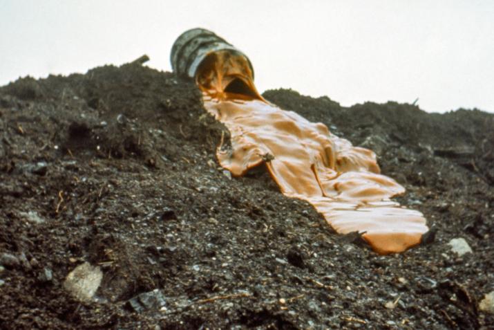 thick orange glue running down a muddy hillside