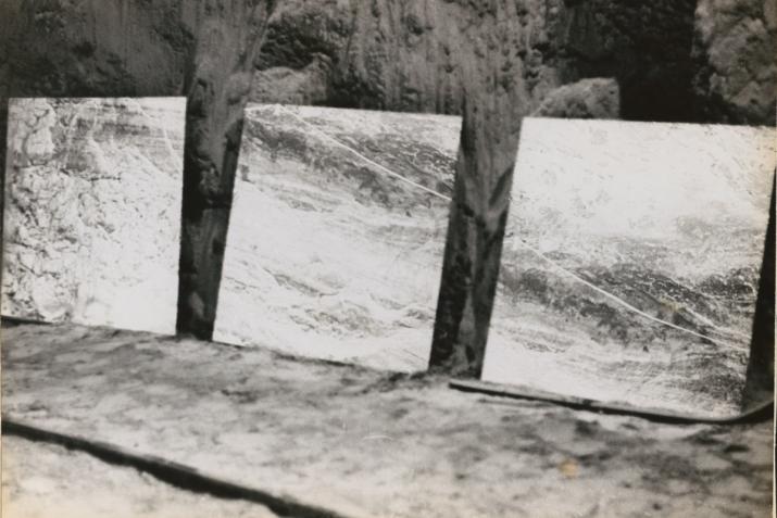 three large mirrors placed on the ground in an underground mine