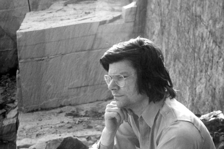 a composite image of a stone quarry and a man sitting pensively in a stone quarry