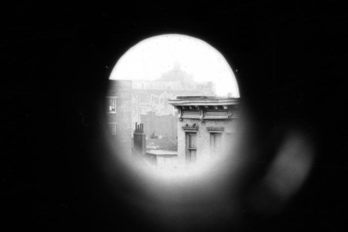 a circular view of a city skyline surrrounded by black