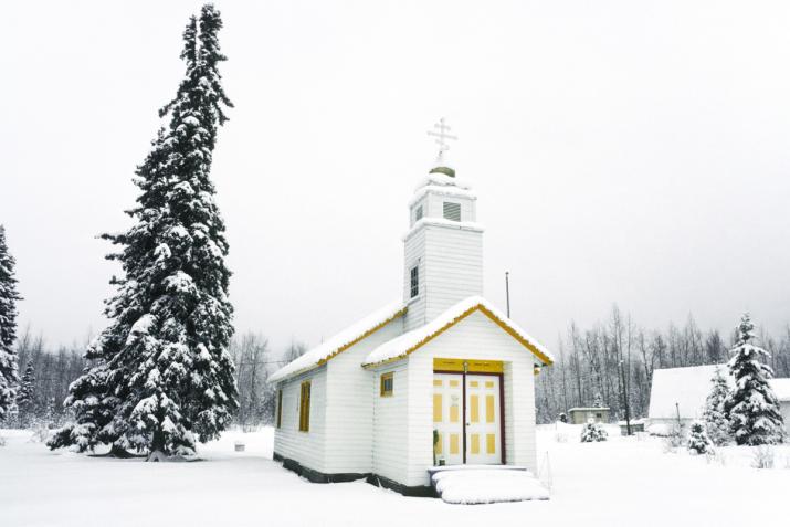 a church in a snowy forest scene