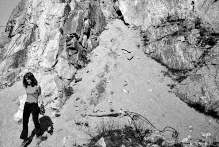 a woman walking down sand dunes