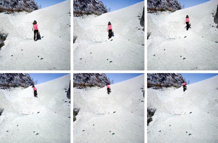 images of a woman walking up a sand dune