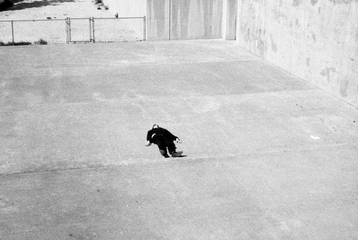 a person lying on a concrete area