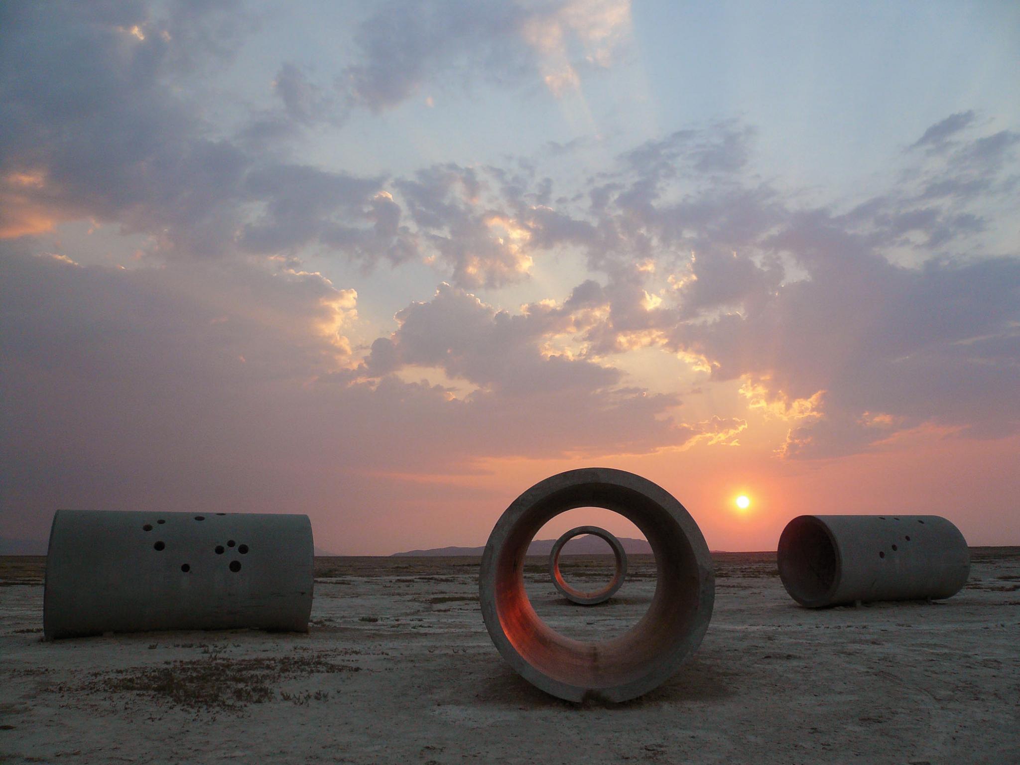The four concrete cylinders that make Sun Tunnels seen in the light of the setting sun.