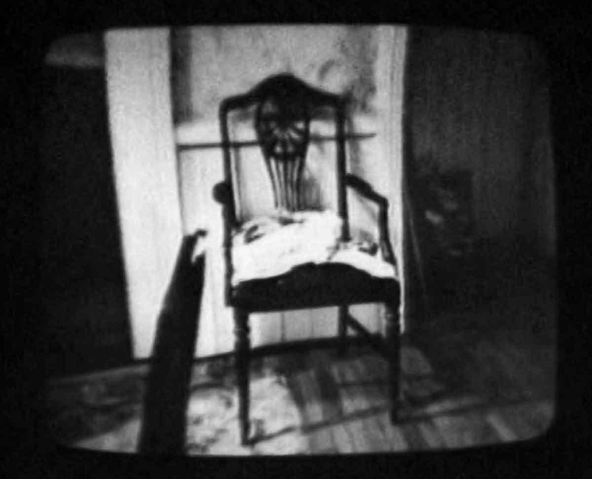 black and white image of a wooden chair in a room