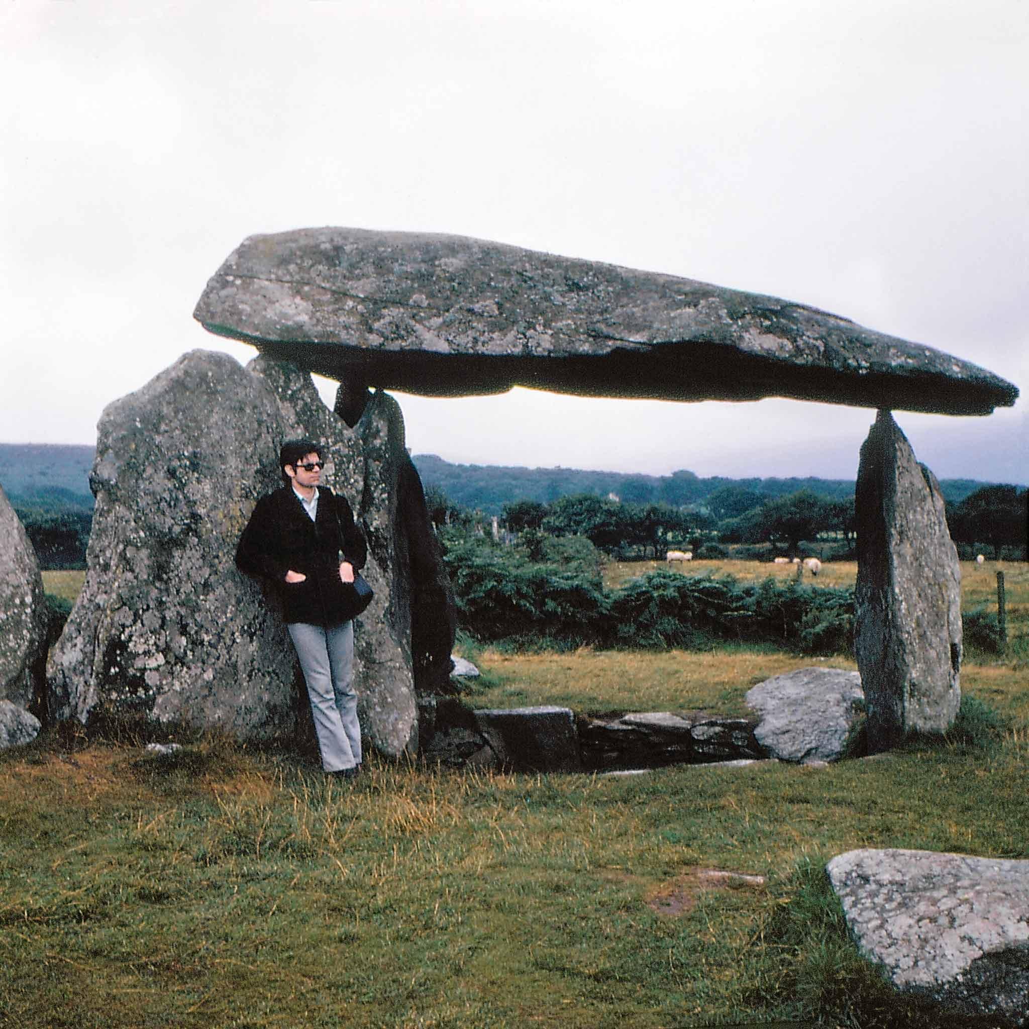 Robert Smithson posing with a dolmen at Pembrokeshire National Park in Wales. Photograph by Nancy Holt.