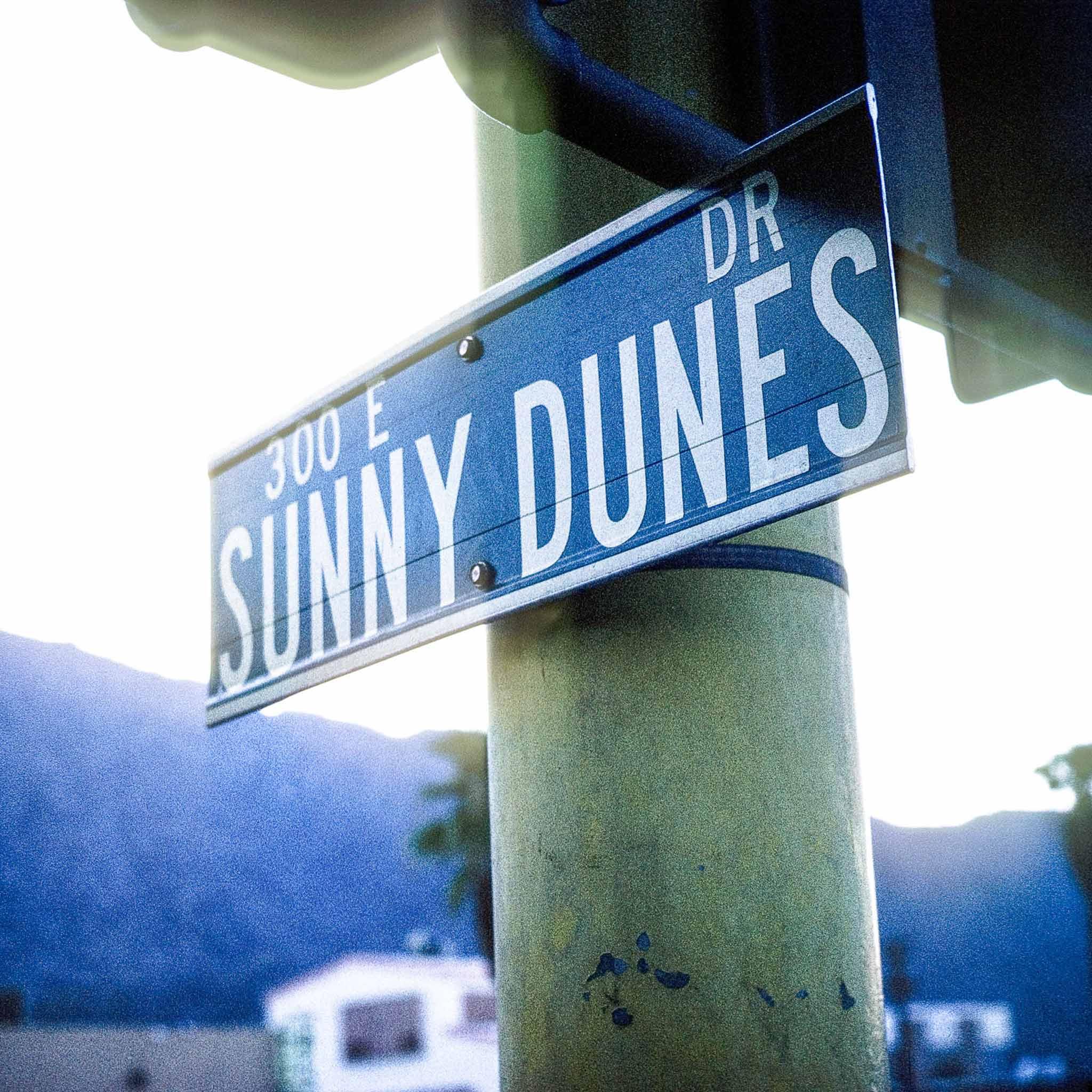 A street sign that reads "Sunny Dunes Dr"