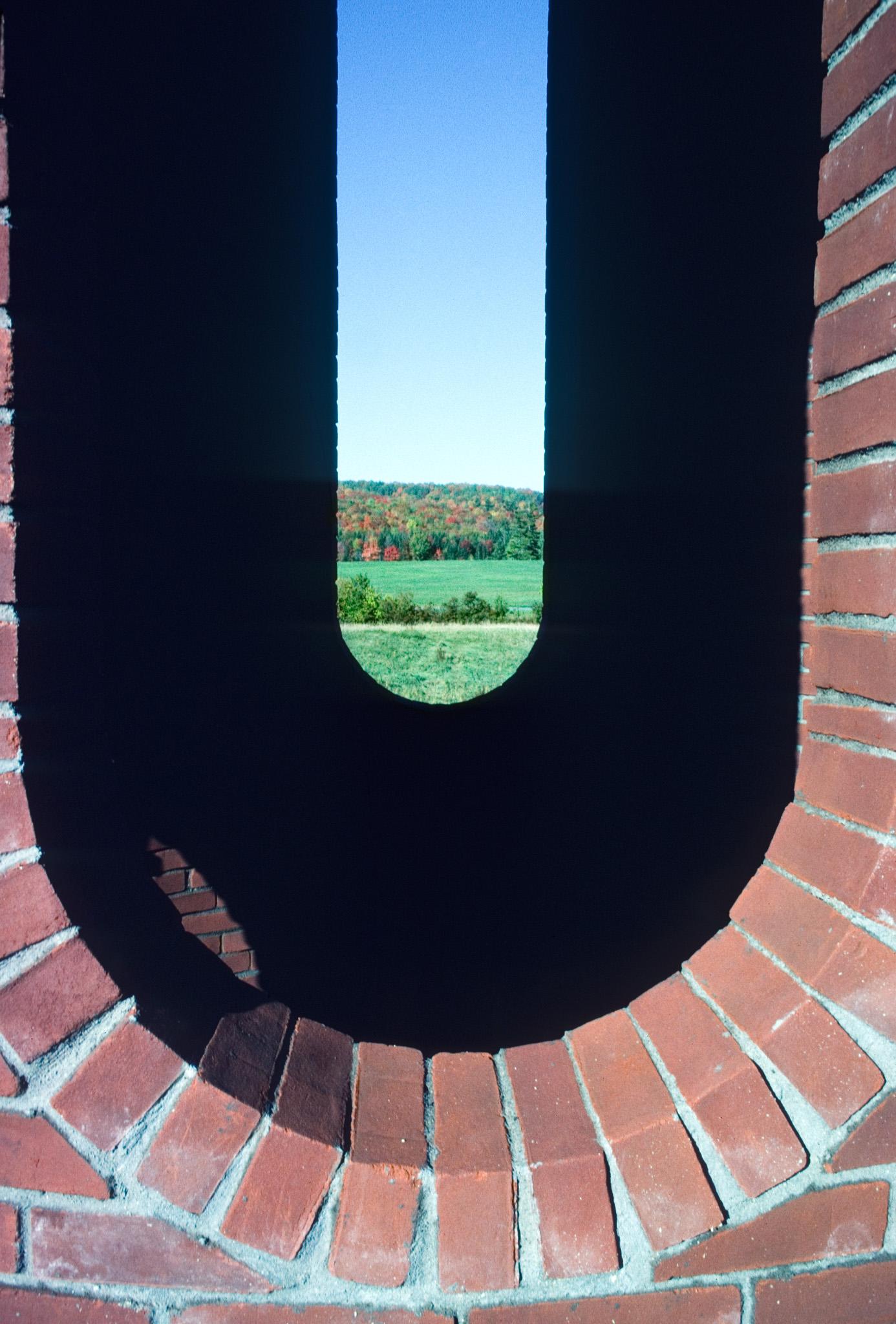 looking through two oval shaped windows in a brick structure
