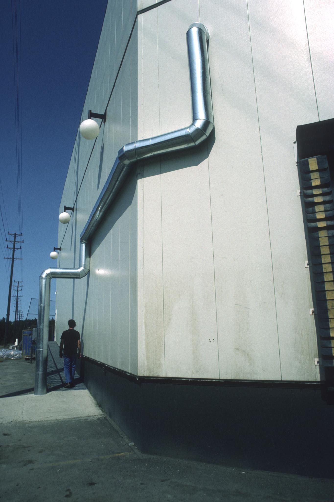 large steel duct zig zagging on the side of a large building