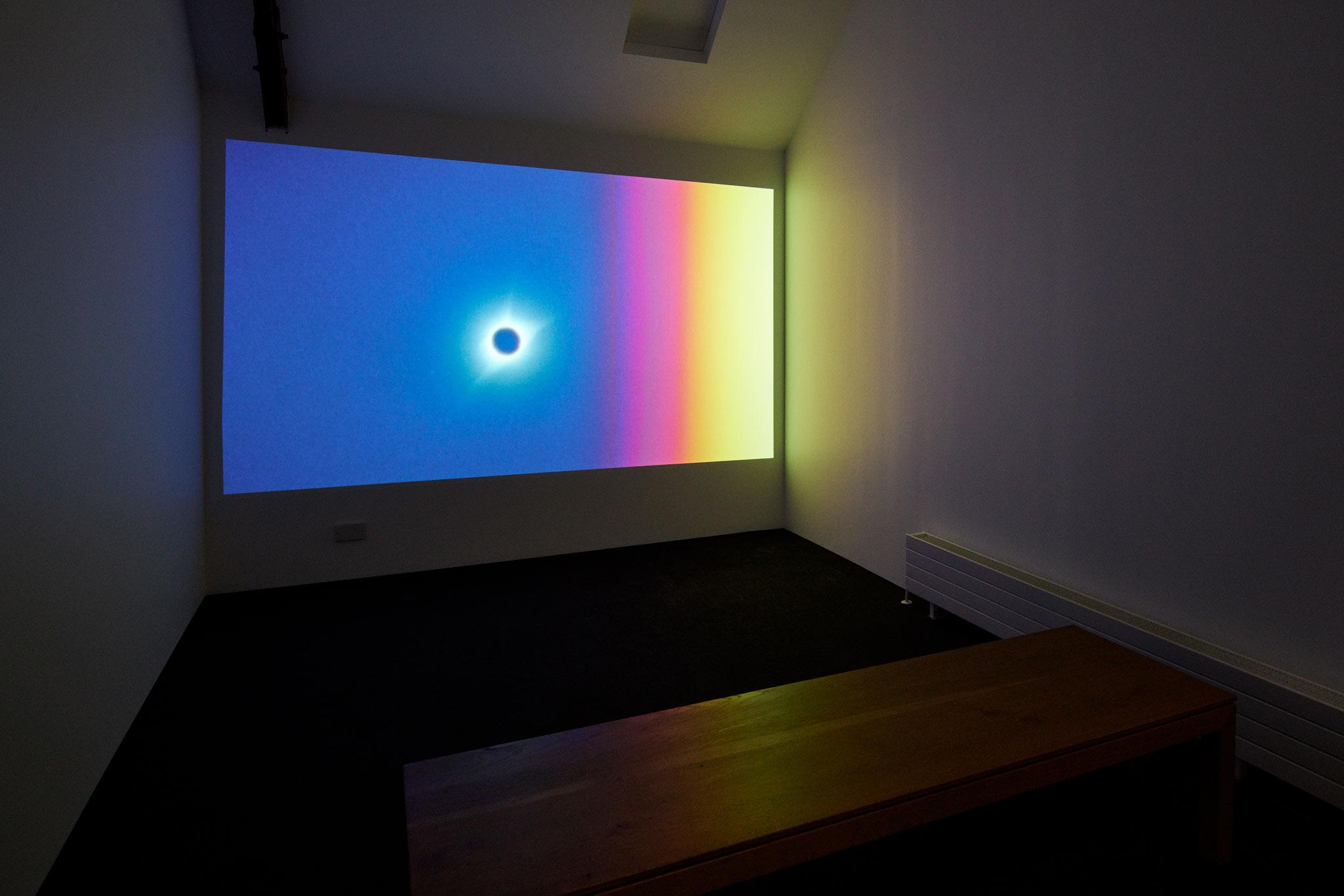 a film screening room displaying a color film of a solar eclipse