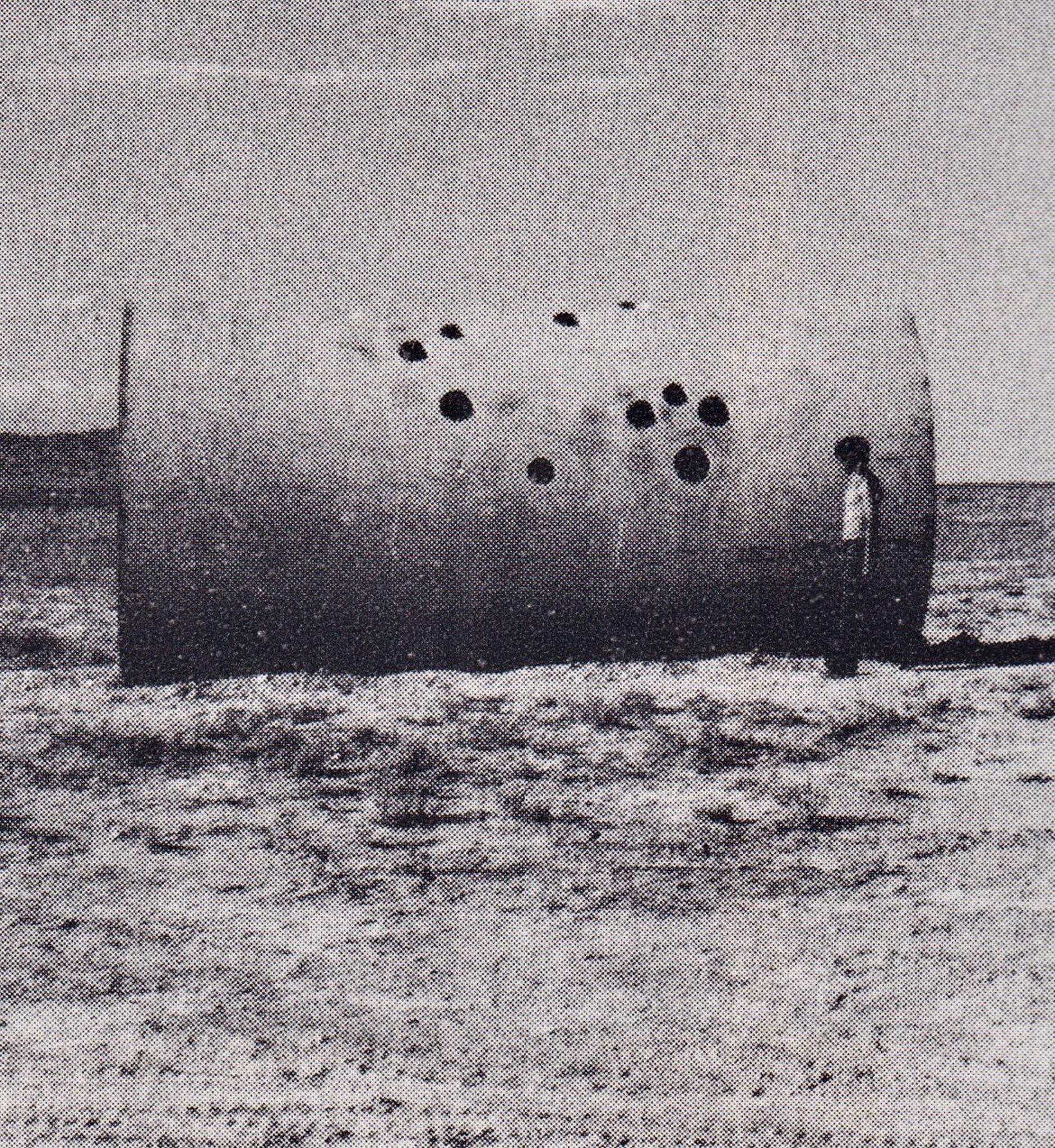 One Sun Tunnel seen from the side with one person standing next to it.