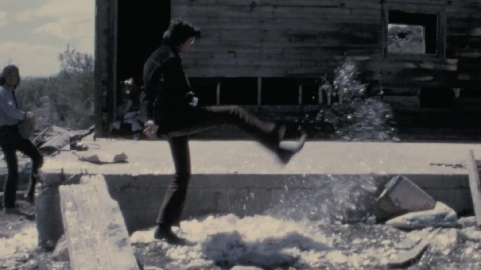 Robert Smithson kicking mica into the air