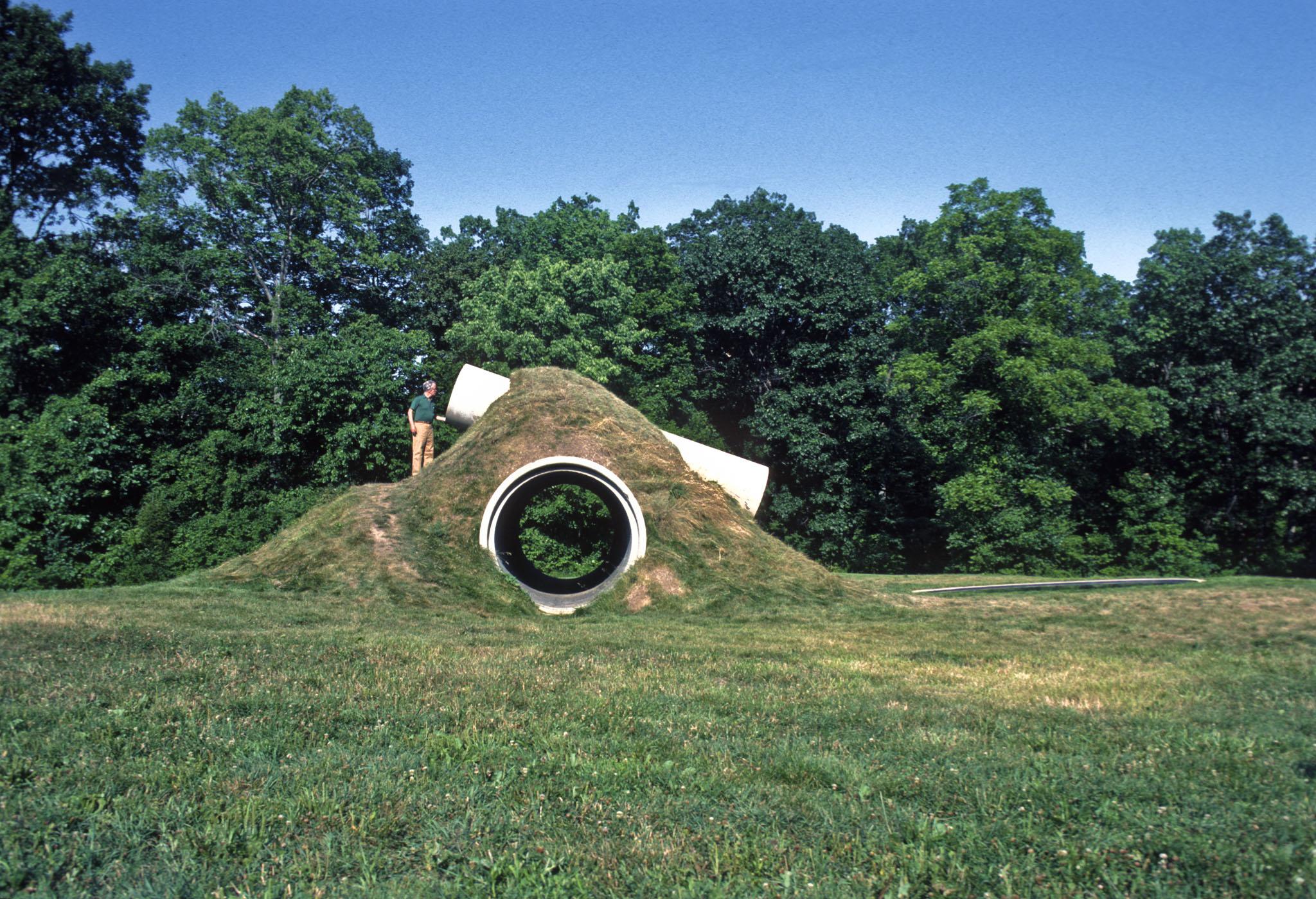 two intersecting large concrete cylinders make up Nancy Holt's Star-Crossed