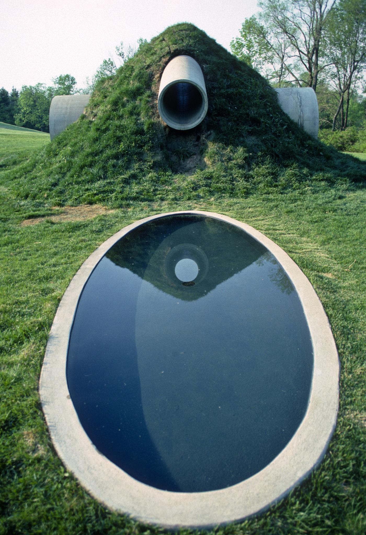 two intersecting large concrete cylinders make up Nancy Holt's Star-Crossed