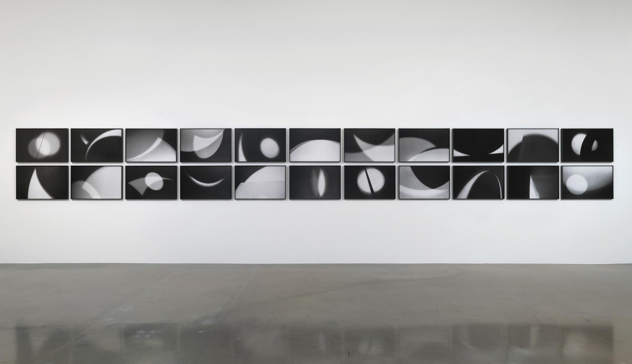 Nancy Holt's light and shadow photo drawings displayed on a gallery wall