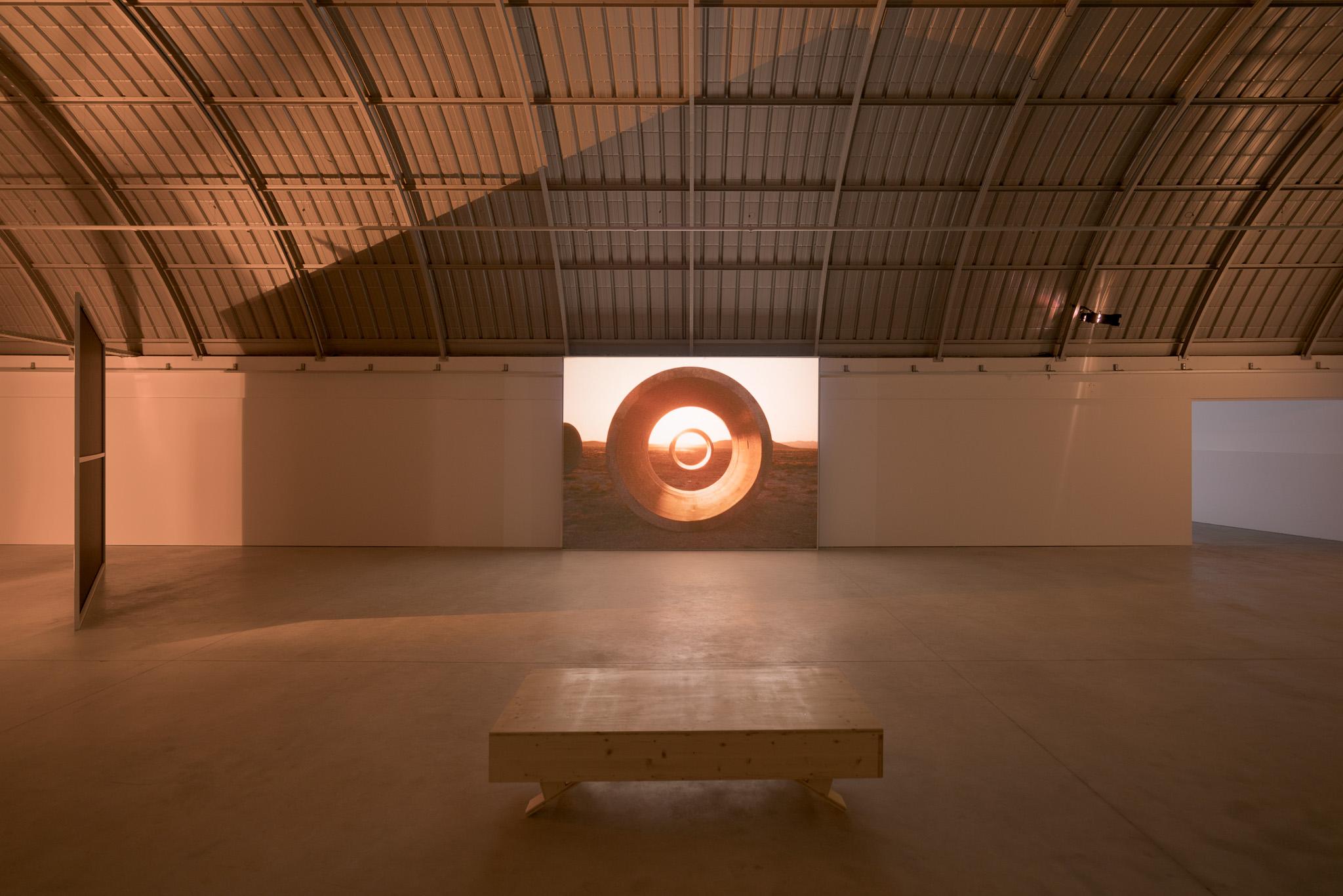 An installation view of Nancy Holt's Sun Tunnels film on display at Centro de Arte Oliva in Portugal