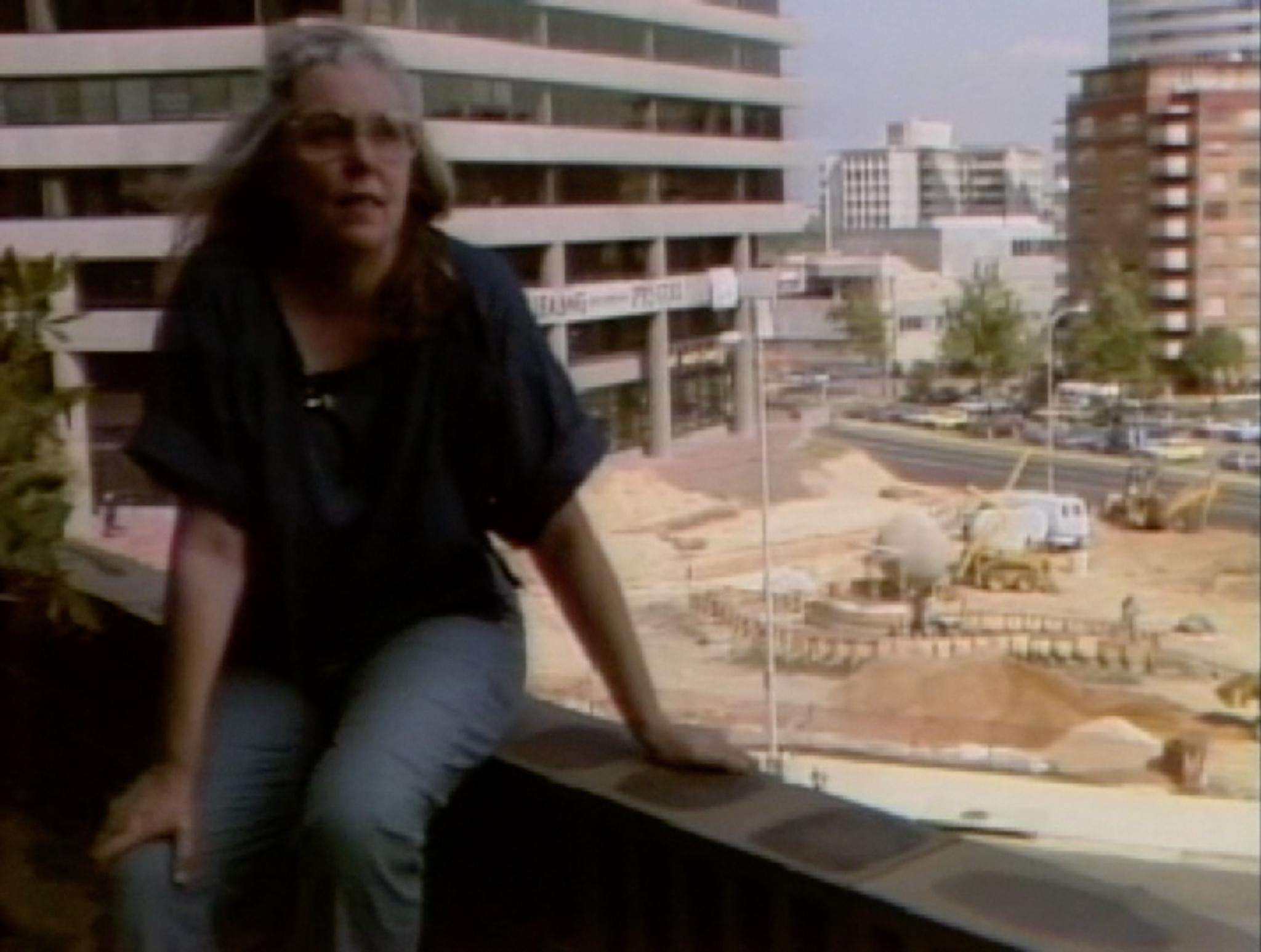 Nancy Holt sitting overlooking the construction site of Dark Star Park