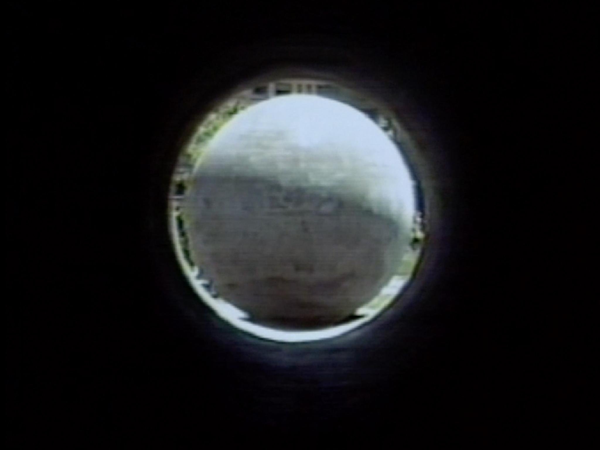 a view through a tunnel framing a sphere