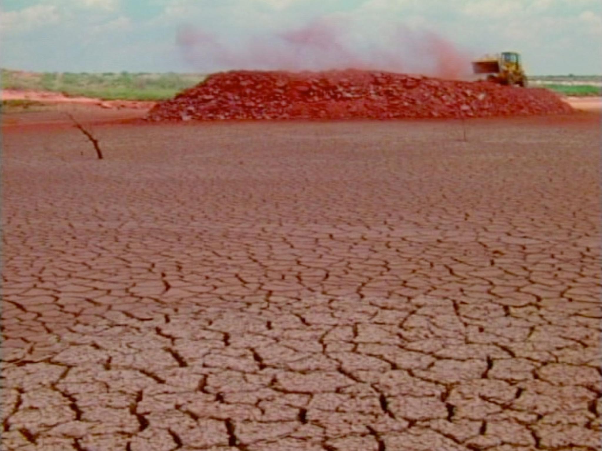 a dry lakebed with cracks in the earth.