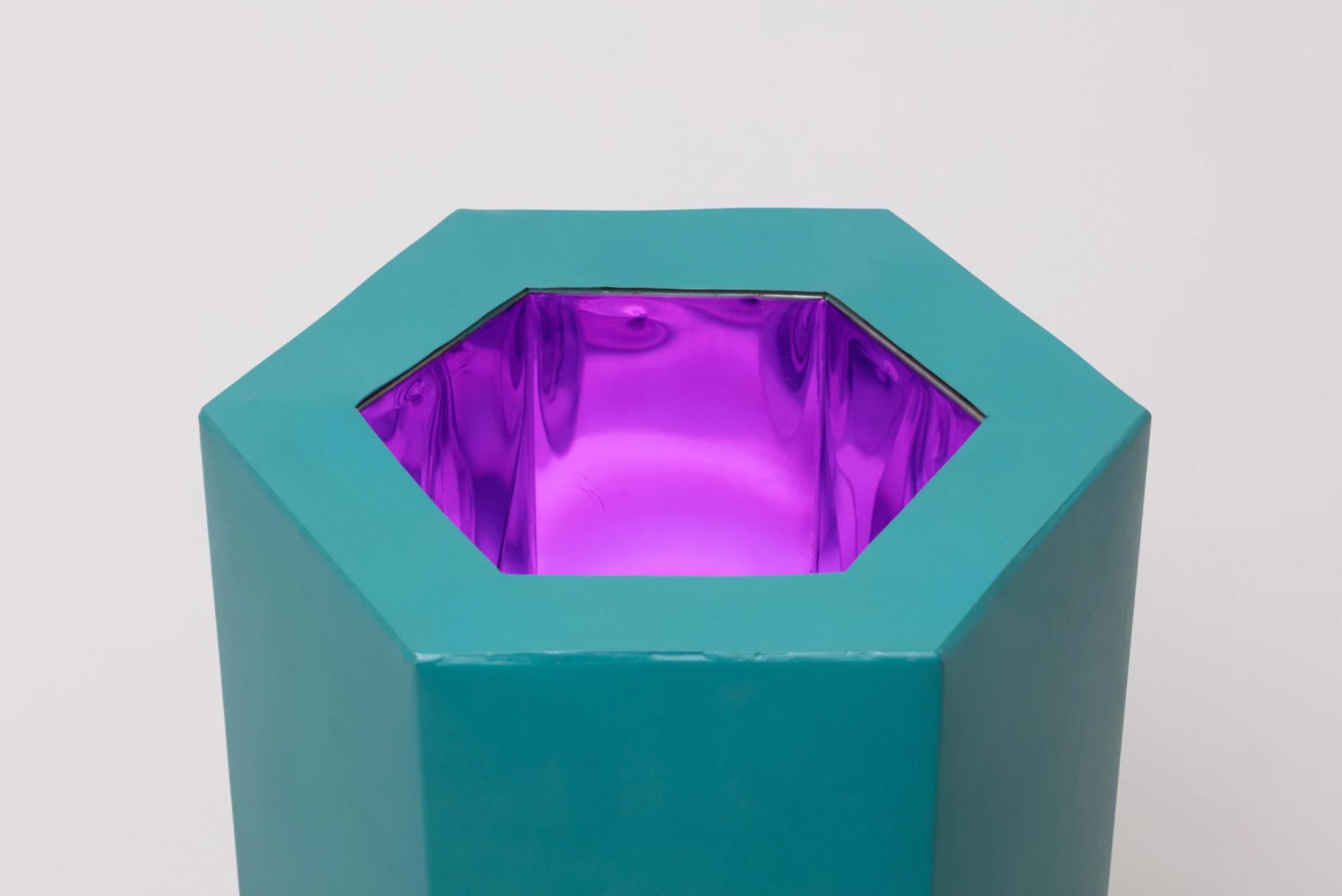 A sculpture by Robert Smithson with a glowing purple center