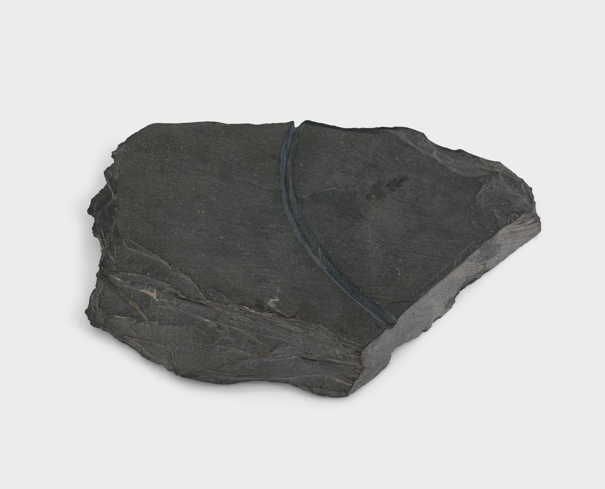 a large piece of slate with a circular incision