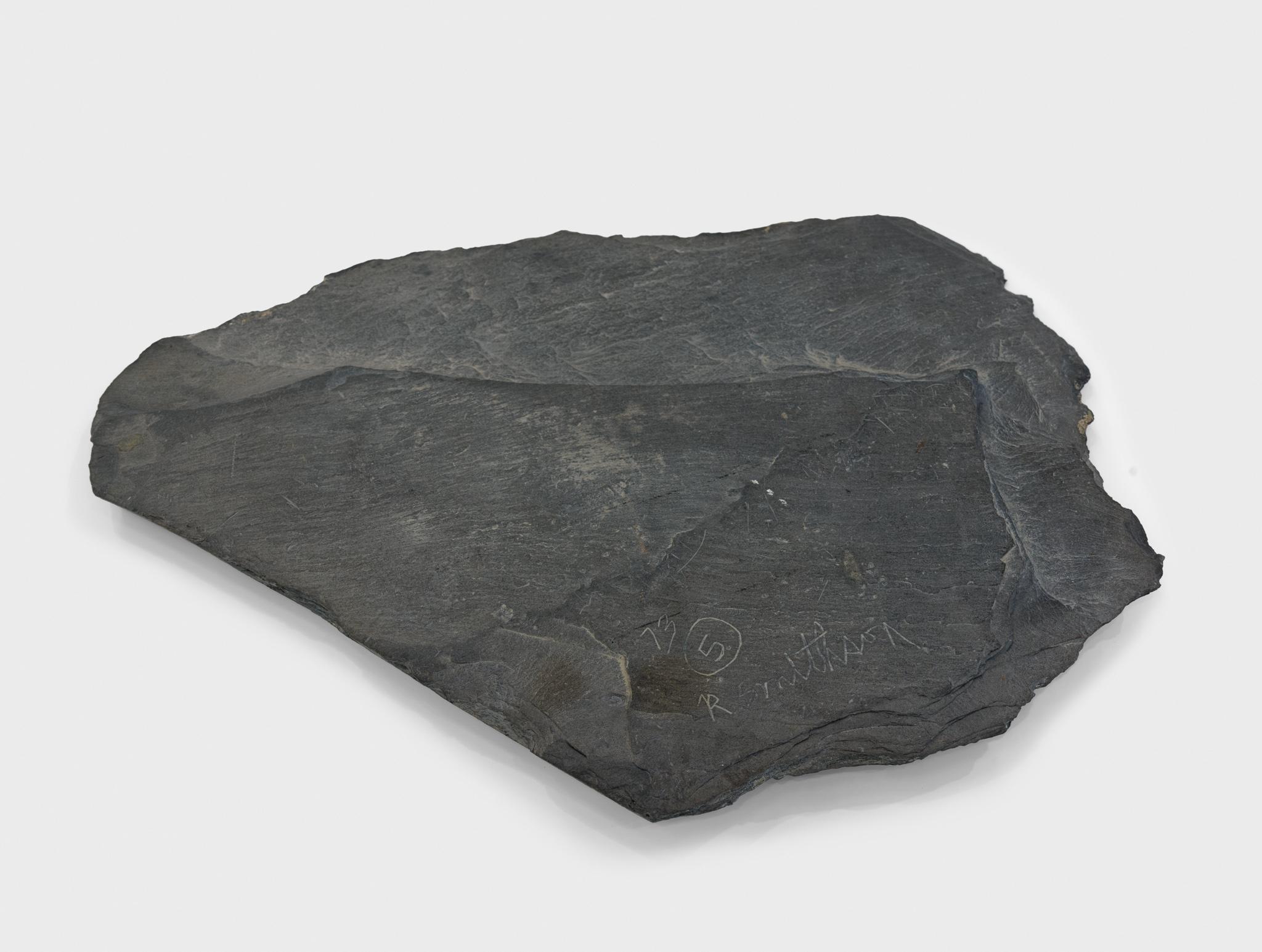 a large piece of slate with a circular incision