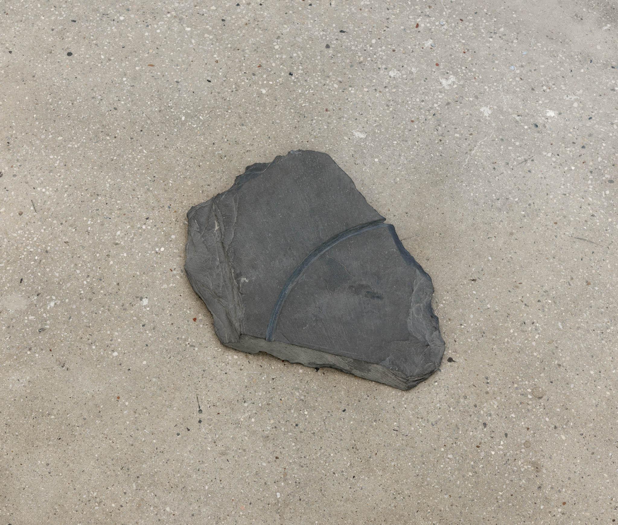 a large piece of slate with a circular incision