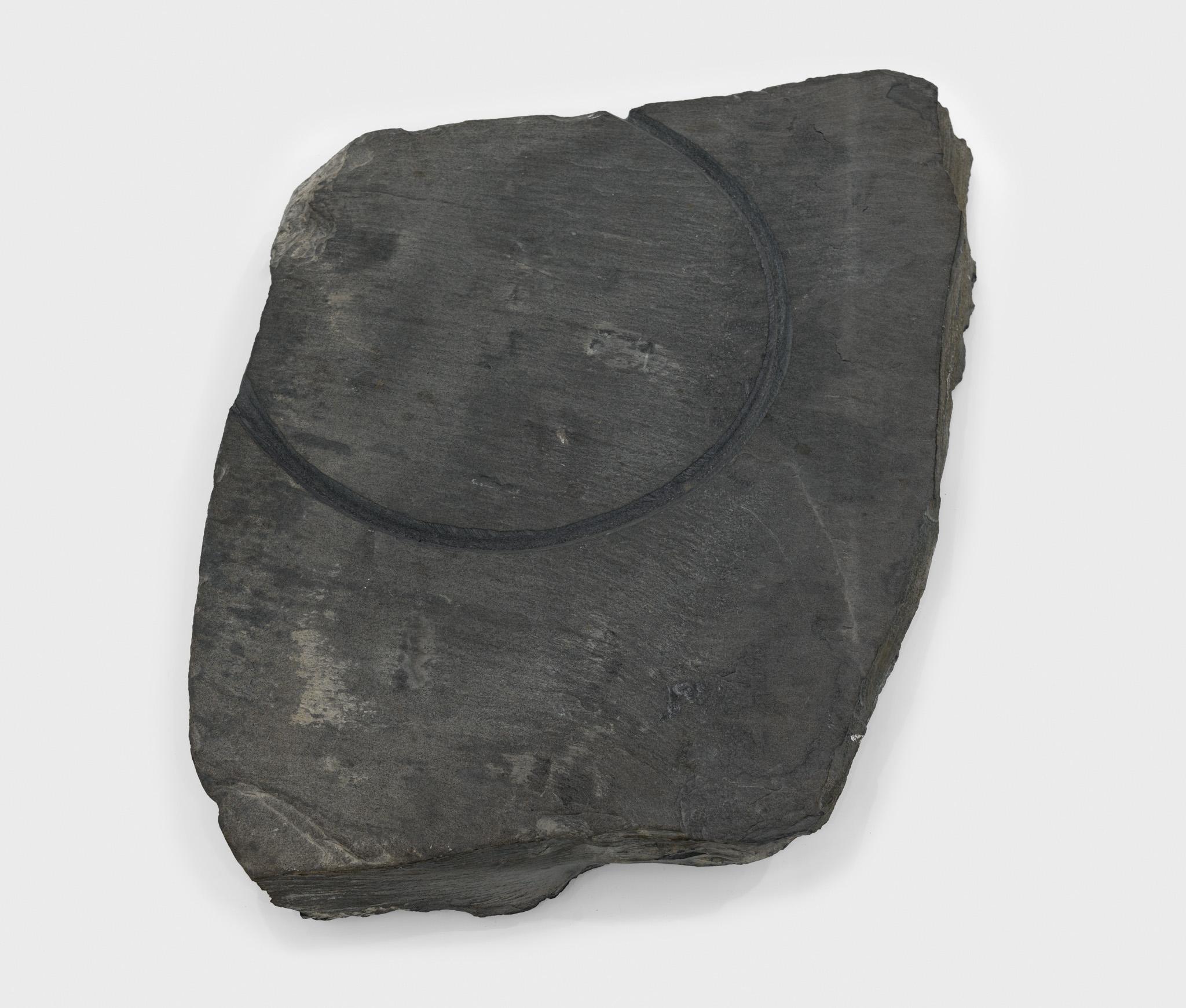 a large piece of slate with a circular incision