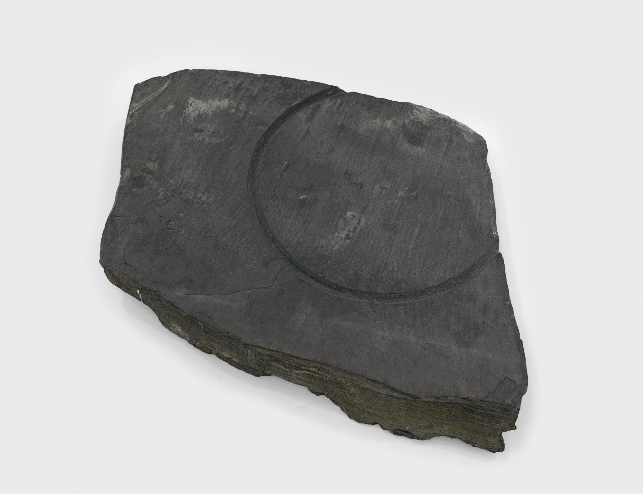 a large piece of slate with a circular incision