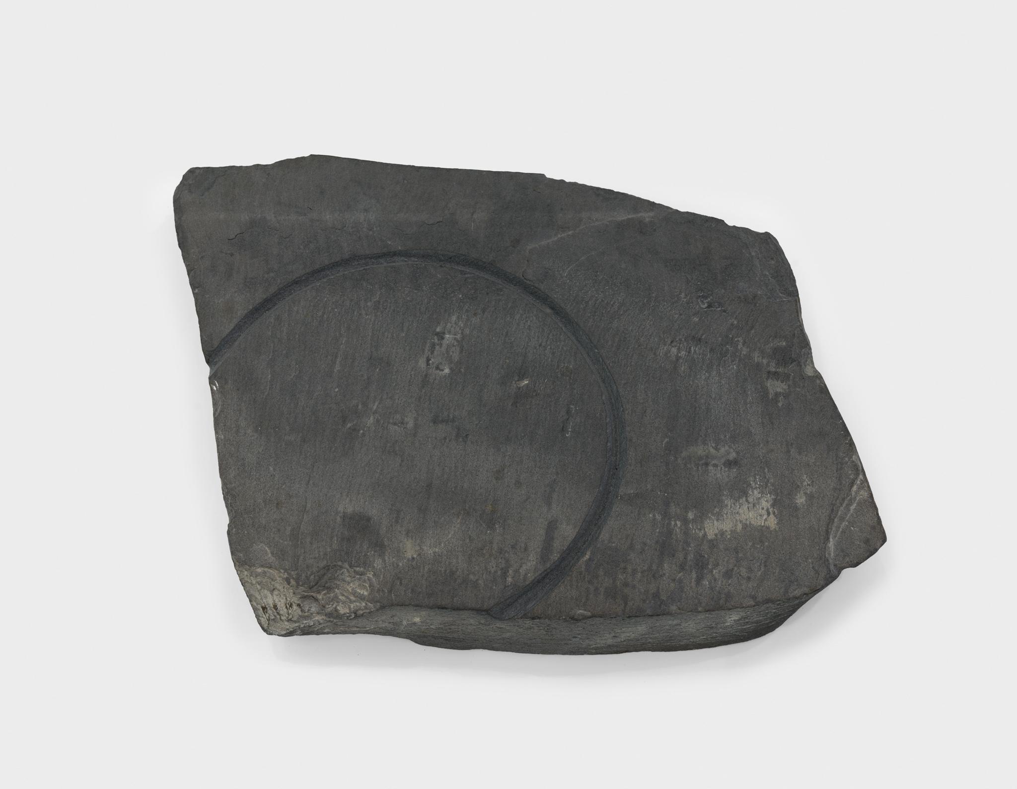 a large piece of slate with a circular incision