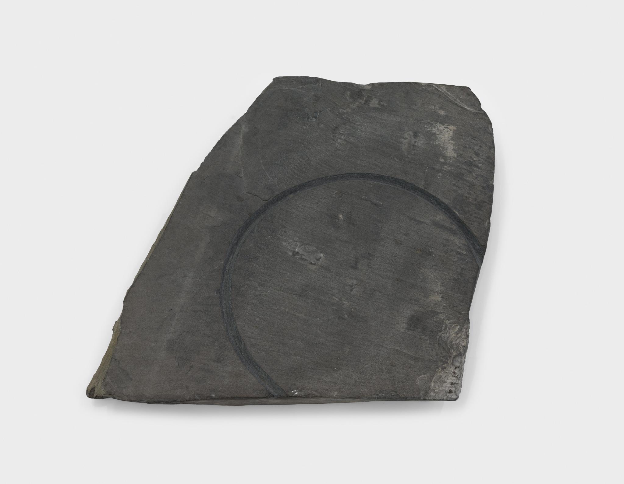 a large piece of slate with a circular incision