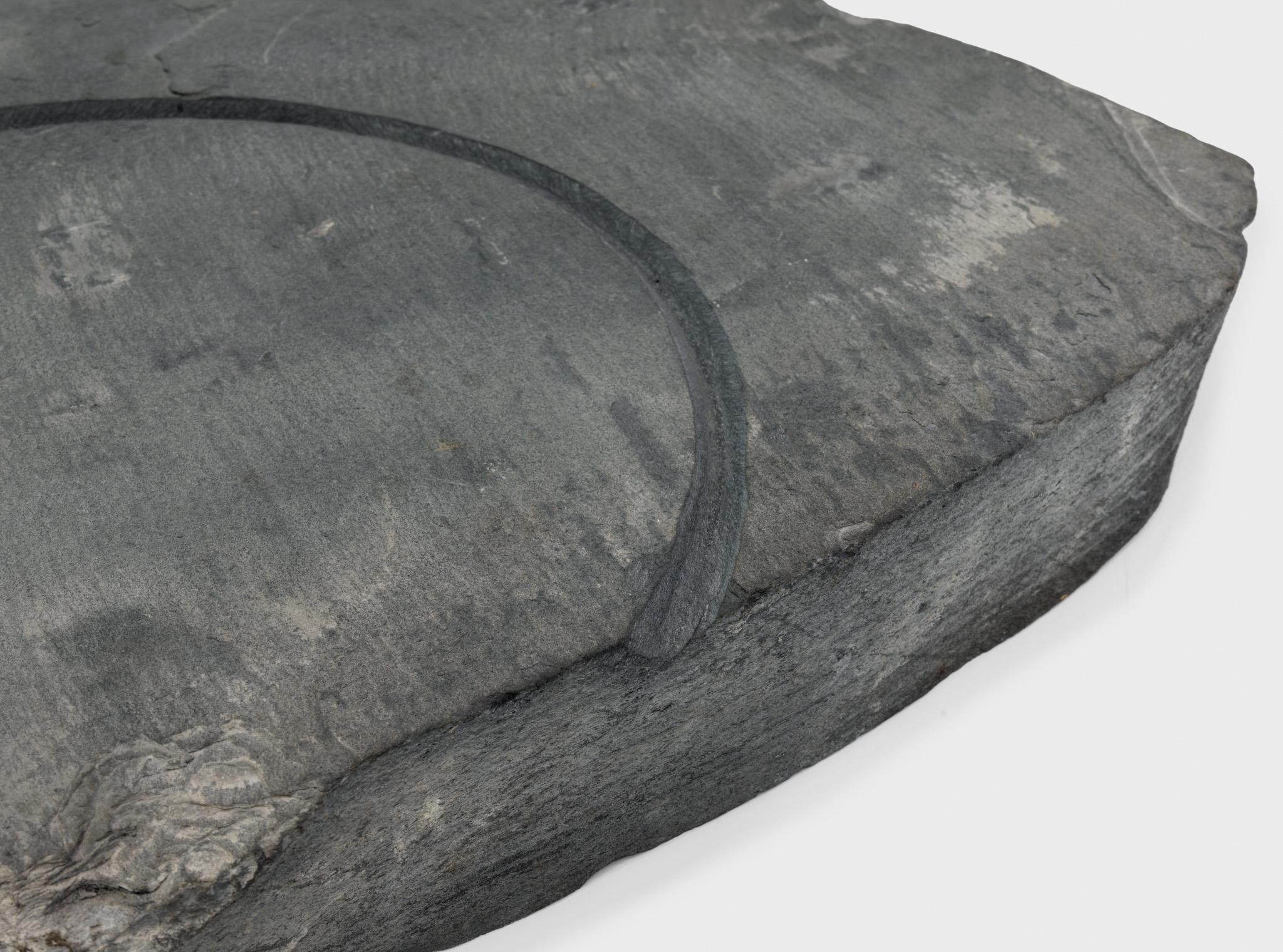 a large piece of slate with a circular incision