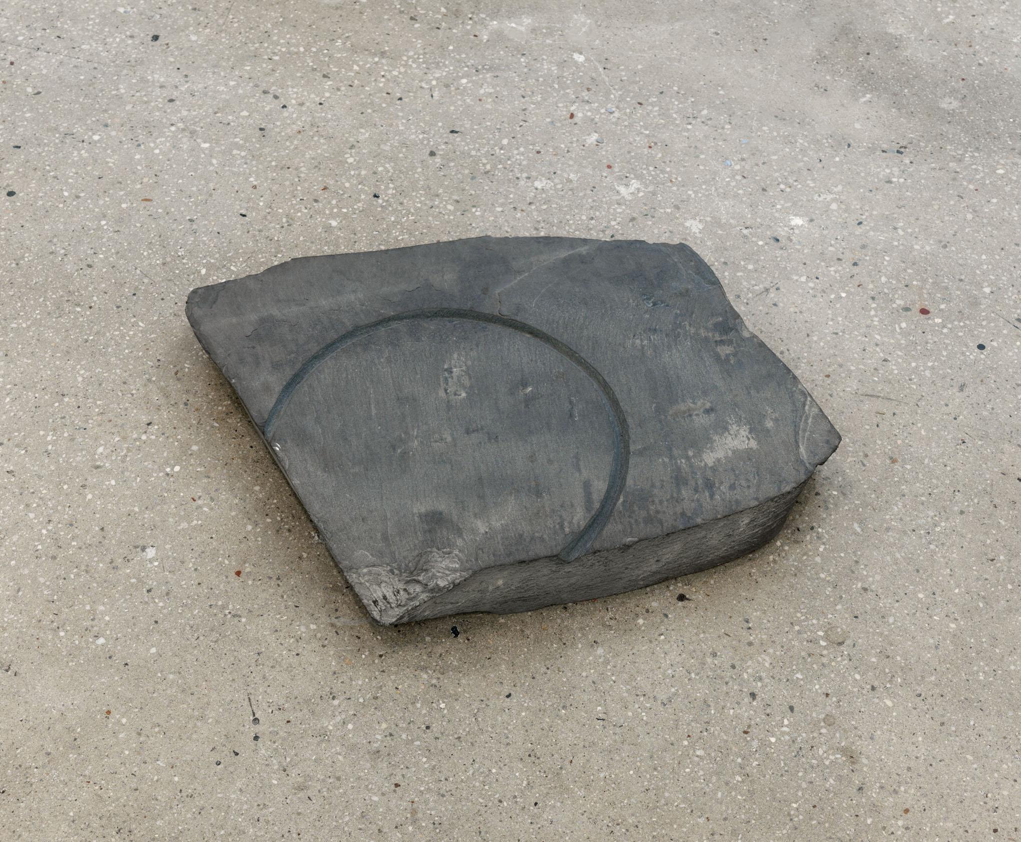 a large piece of slate with a circular incision