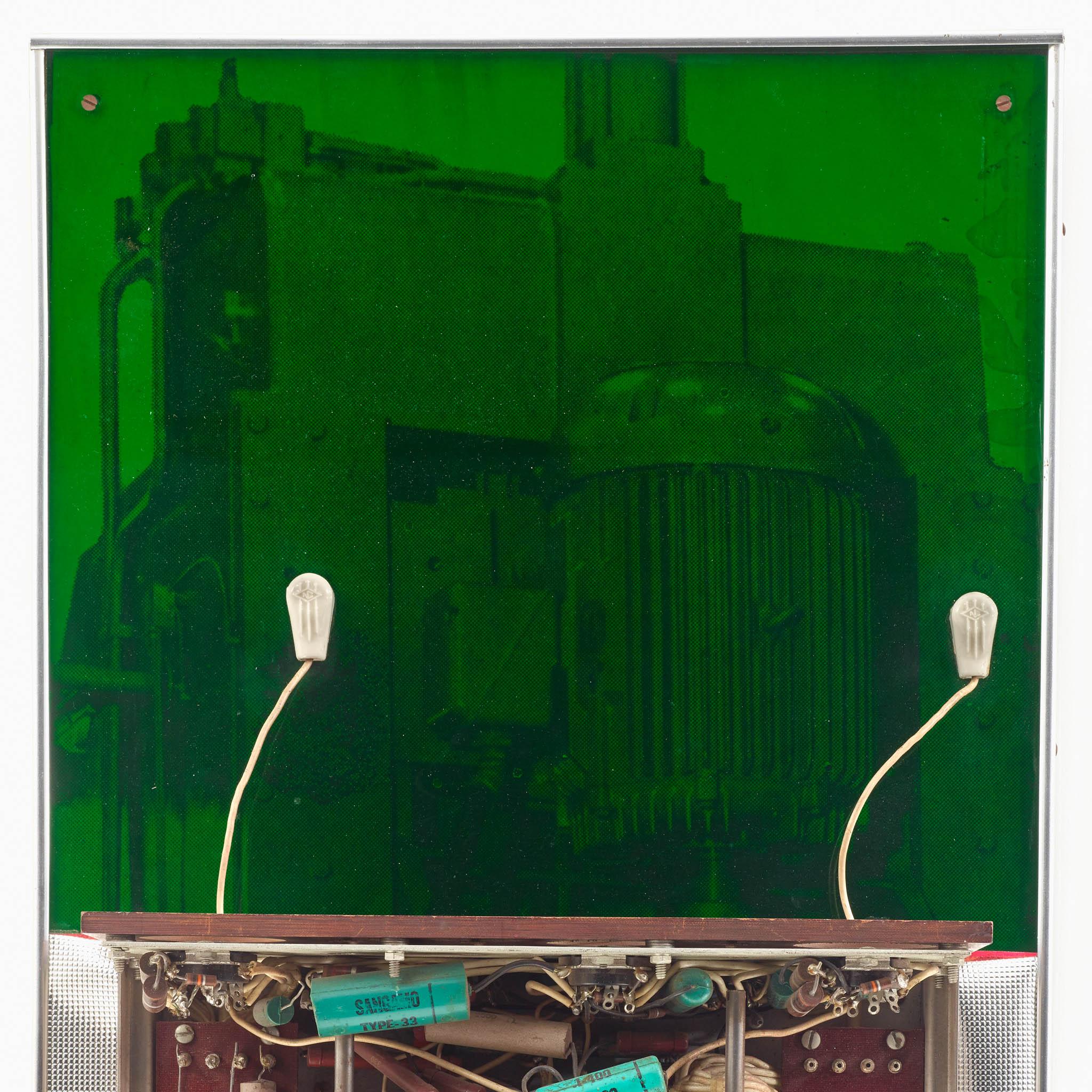 a wall sculpture with bright neon colors and machine parts interacting with a cutout image of a woman